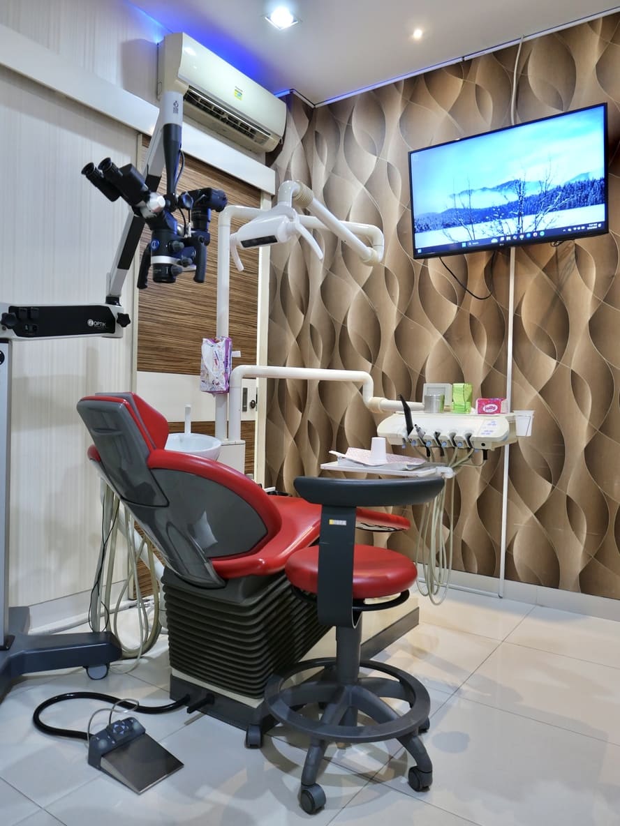 Treatment room with dental chair, microscope, and wave-panel wall