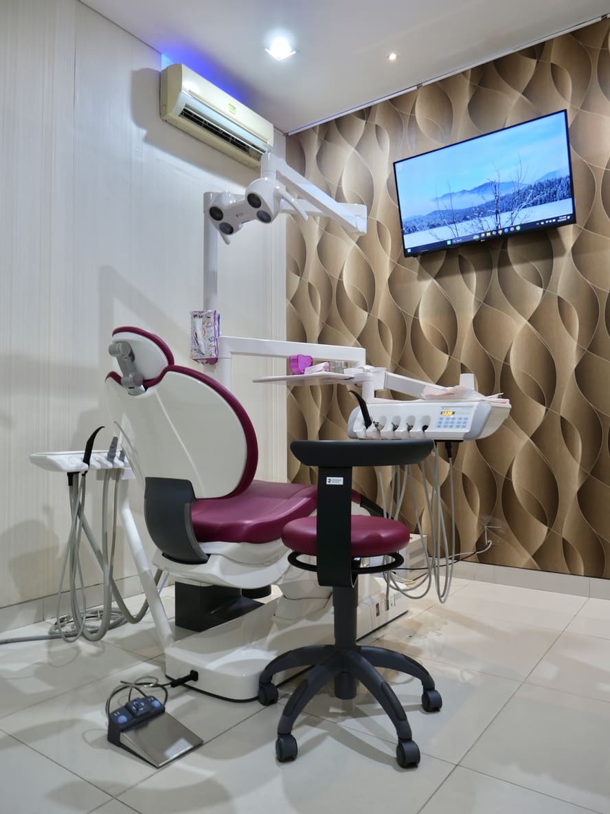 Modern treatment room with crimson dental chair